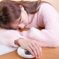 Resting a hand on the heated palm massager
